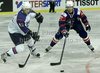 Andrej Hebar (no.21) of Slovenia (R) and Dong Hwan Kim (no.12) of Korea (L) during ice hockey match of IIHF Ice hockey World championships Division I, group B between Slovenia and Korea. Match between Slovenia and Korea of IIHF Ice hockey World championships Division I, group B was held on Wednesday, 21st of April 2010 in Ljubljana, Slovenia.

